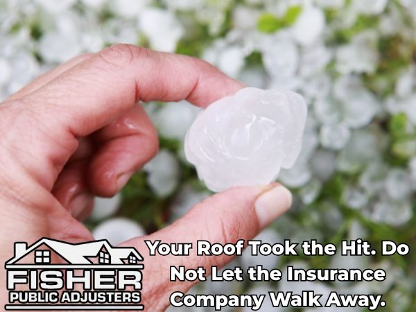 Hand holding large hailstone with Fisher Public Adjusters logo and message about roof damage and denied insurance claims